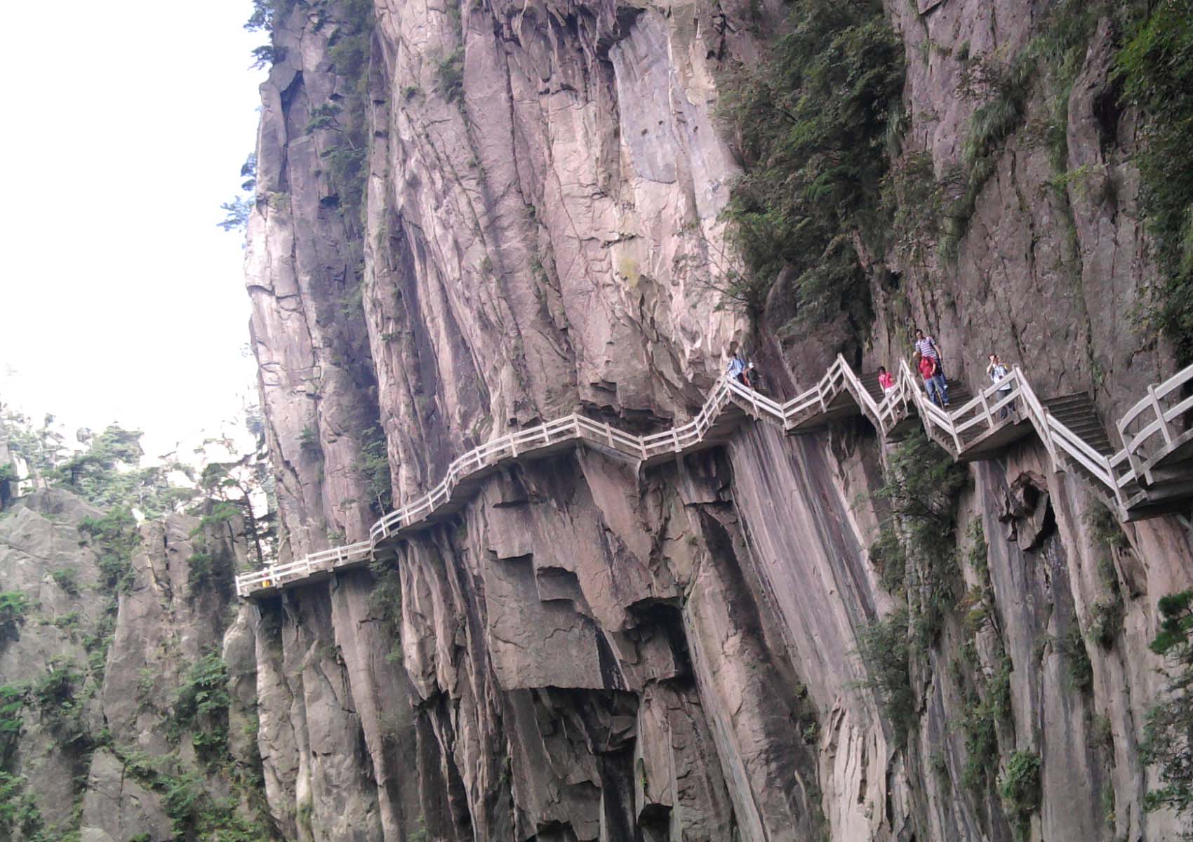 Built visitor steps zigzag across a steep cliff in Huangshan's West Sea Grand Canyon.