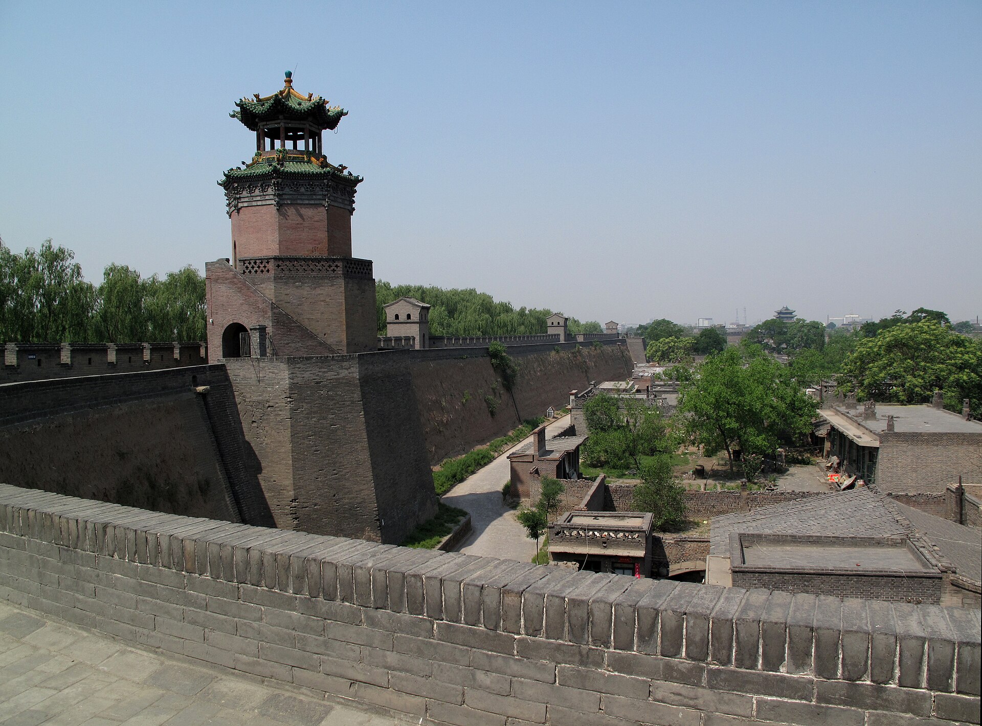 Pingyao's city wall and a corner tower overlook low grey-roofed streets inside the old city in 2009.